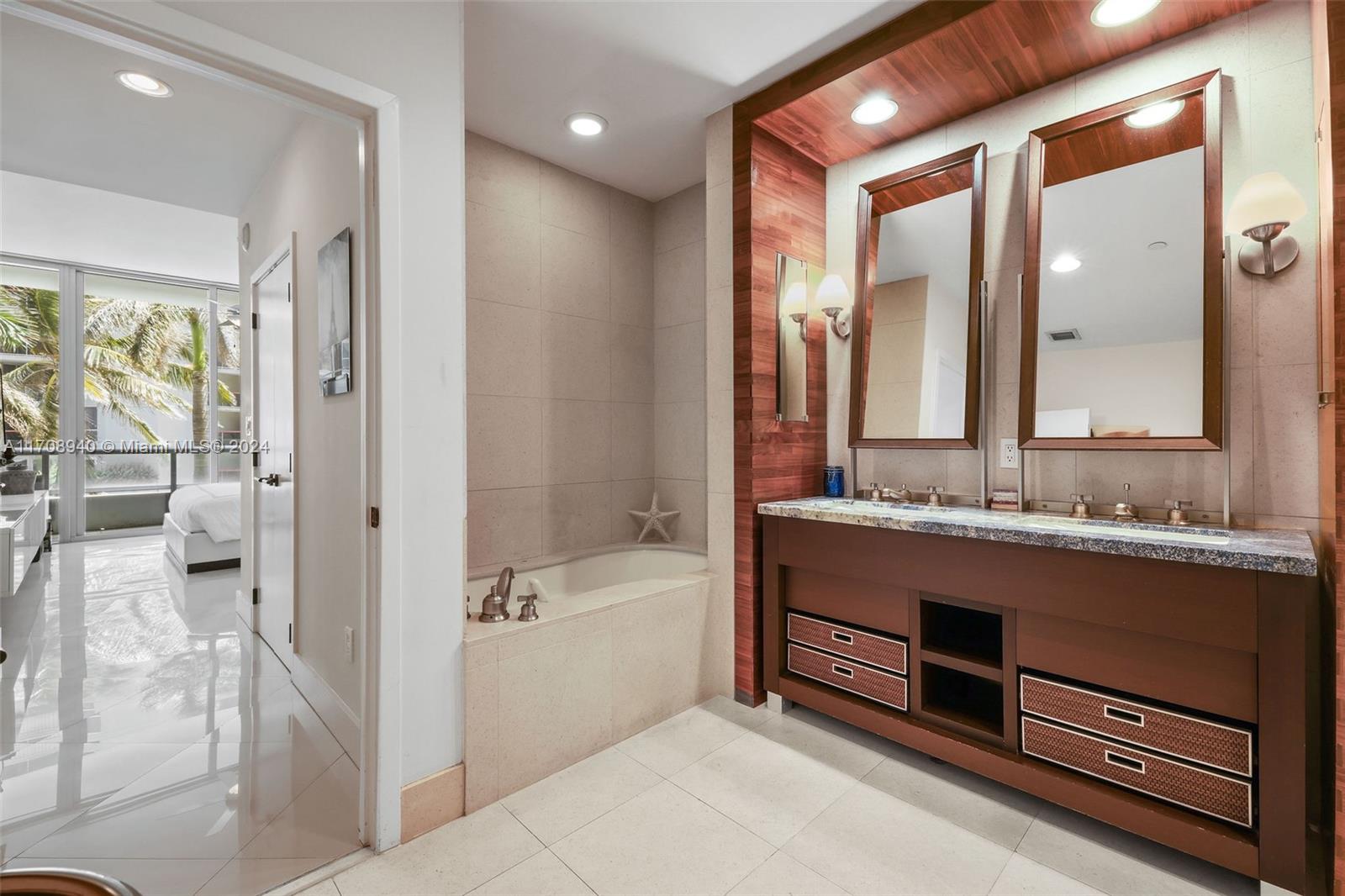 6799 Collins Avenue, Unit 207 Miami Beach, FL 33141 - Photo 17 of 35 a bathroom with a bathtub and a sink