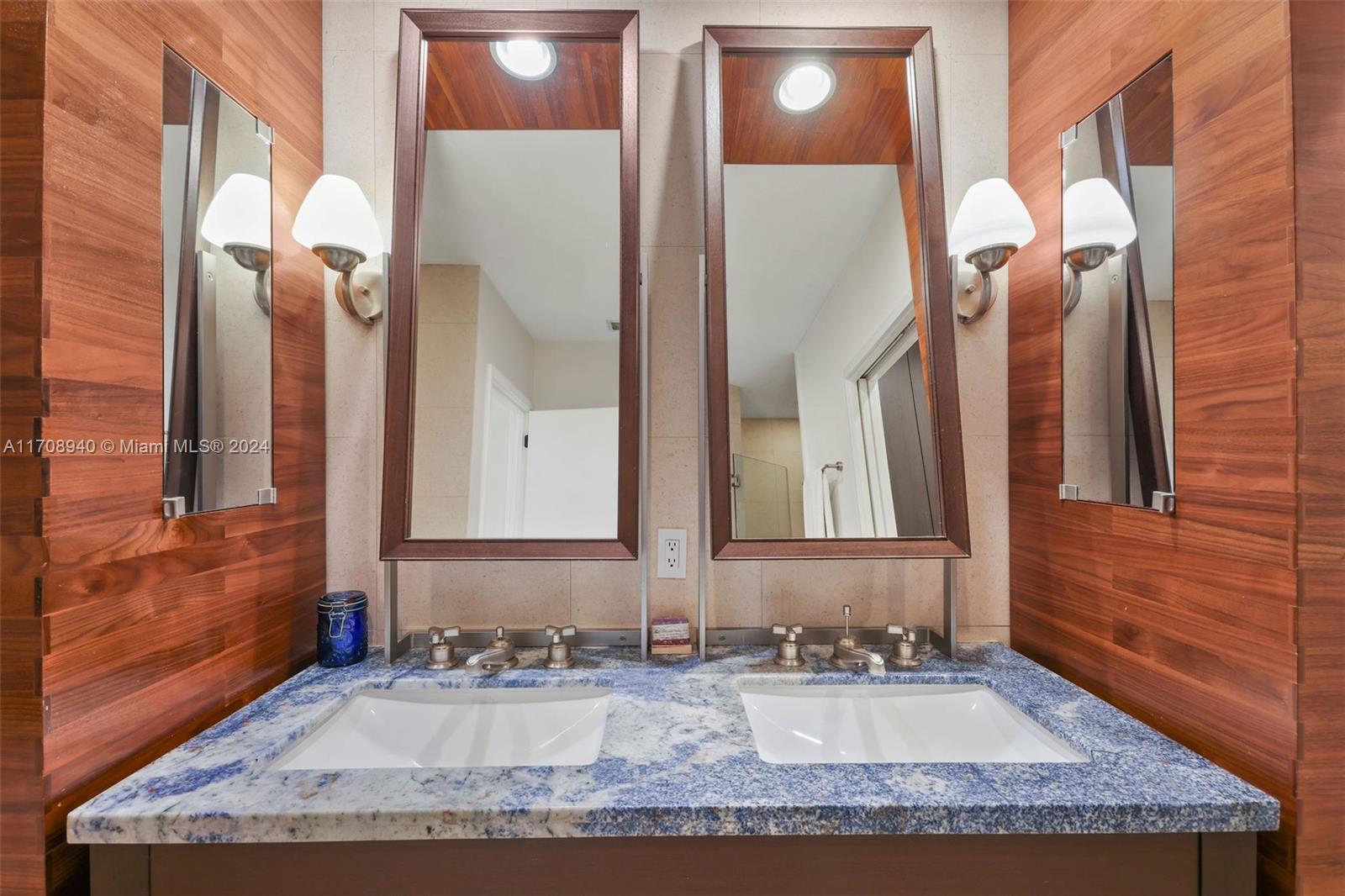 6799 Collins Avenue, Unit 207 Miami Beach, FL 33141 - Photo 21 of 35 a bathroom with a granite countertop sink and a mirror