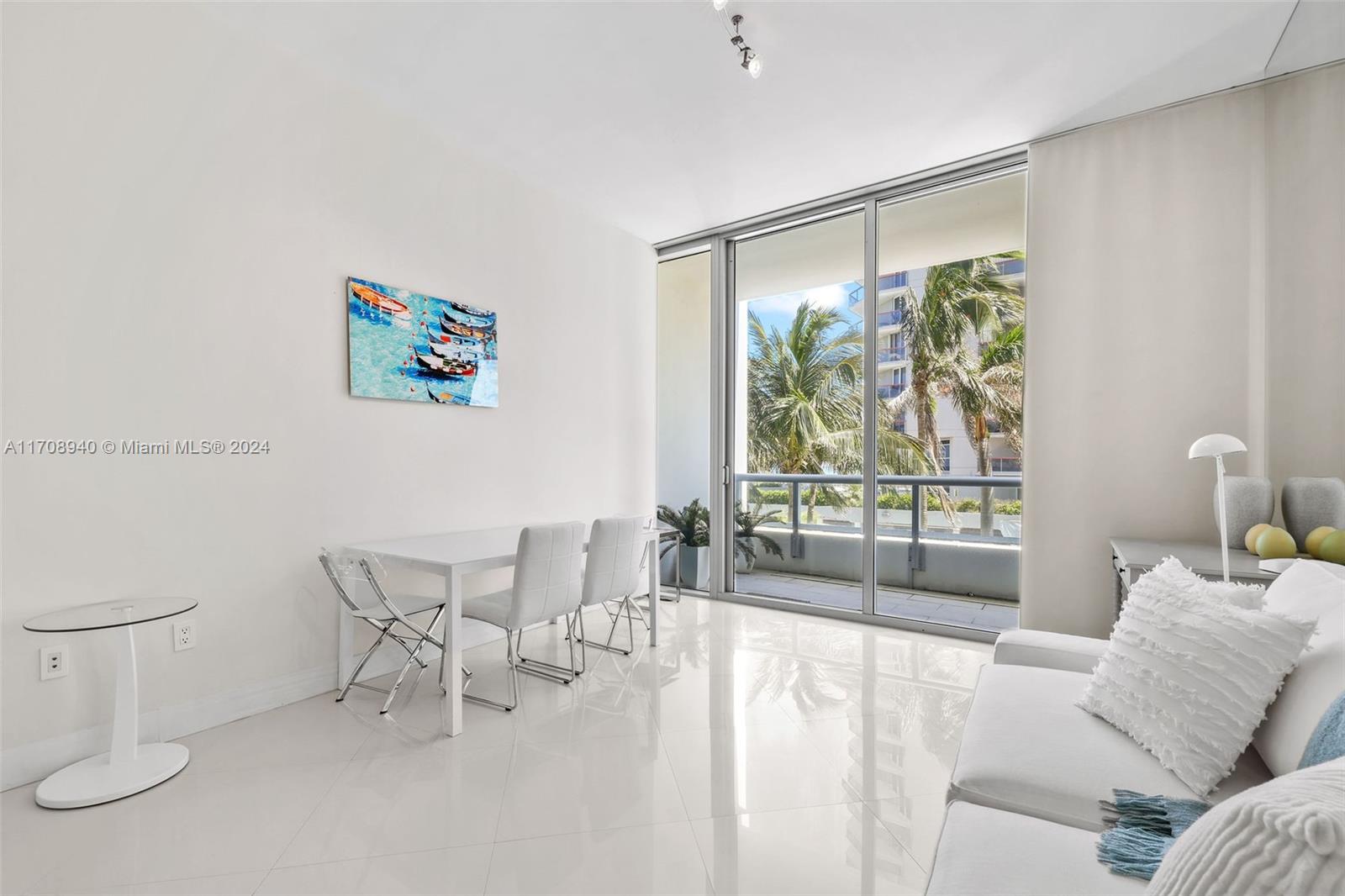 6799 Collins Avenue, Unit 207 Miami Beach, FL 33141 - Photo 4 of 35 a living room with furniture and a large window