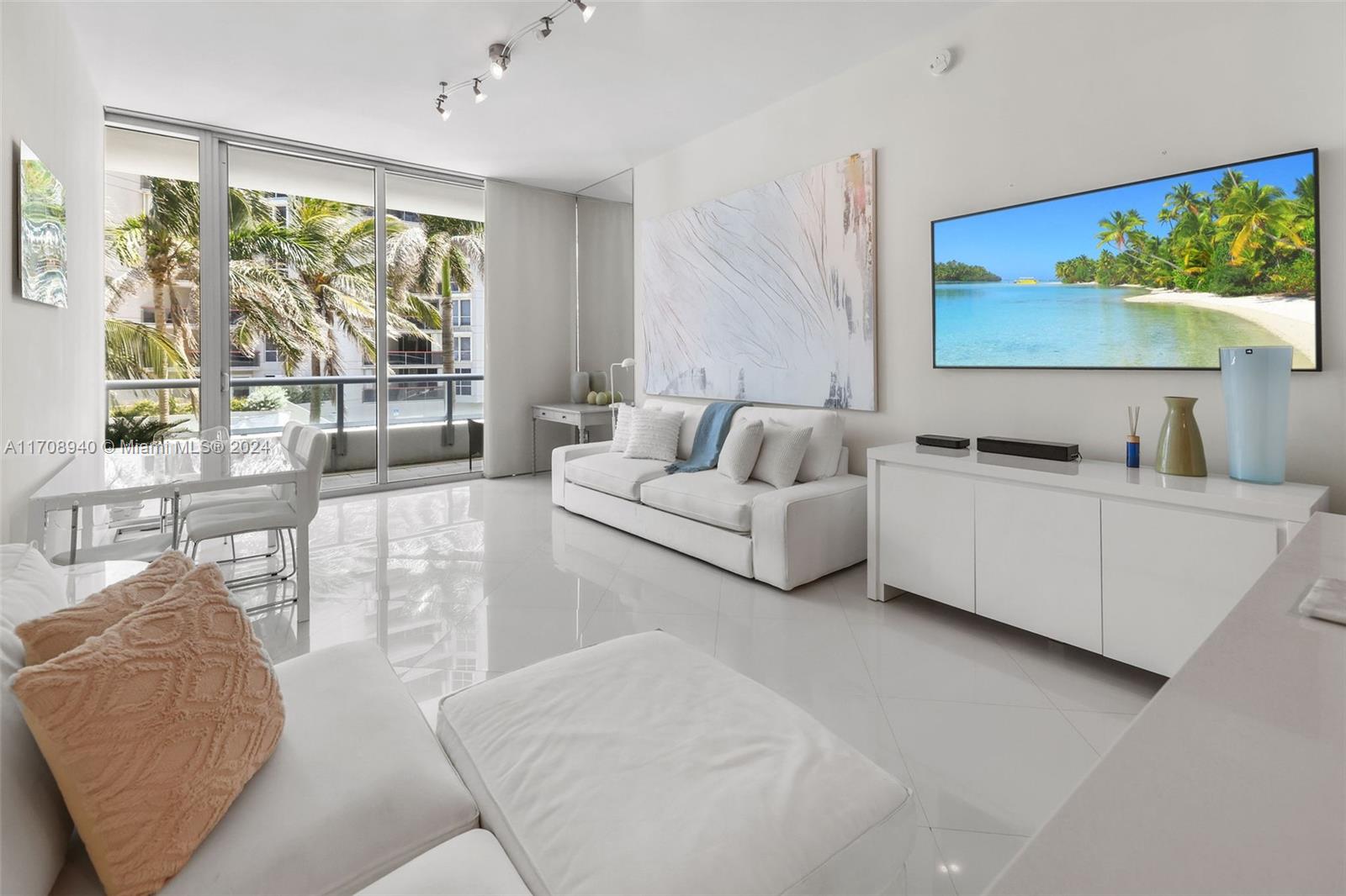 6799 Collins Avenue, Unit 207 Miami Beach, FL 33141 - Photo 7 of 35 a living room with furniture and a large window