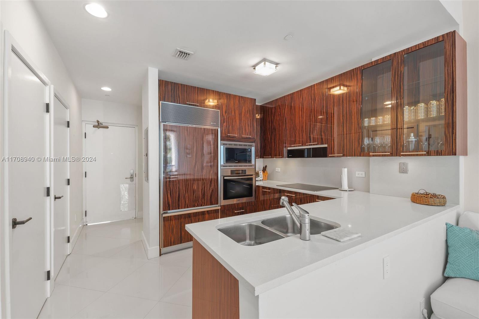 6799 Collins Avenue, Unit 207 Miami Beach, FL 33141 - Photo 8 of 35 a kitchen with stainless steel appliances granite countertop a sink and a refrigerator