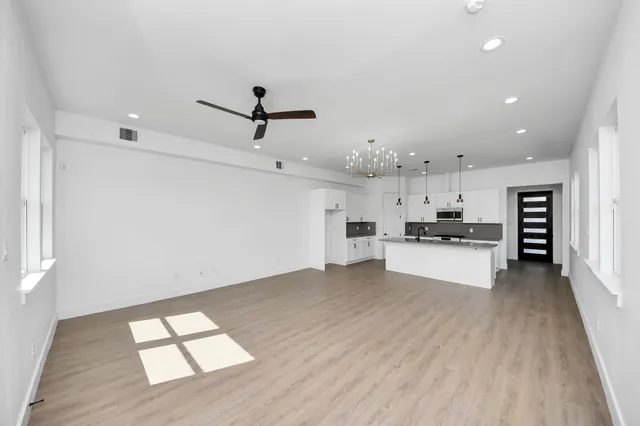 a kitchen with stainless steel appliances kitchen island sink refrigerator and stove