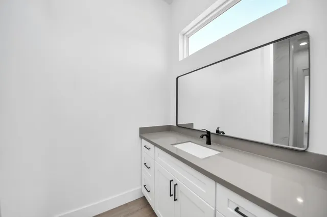 a bathroom with a sink and a mirror