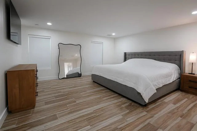 a bedroom with a bed and a television