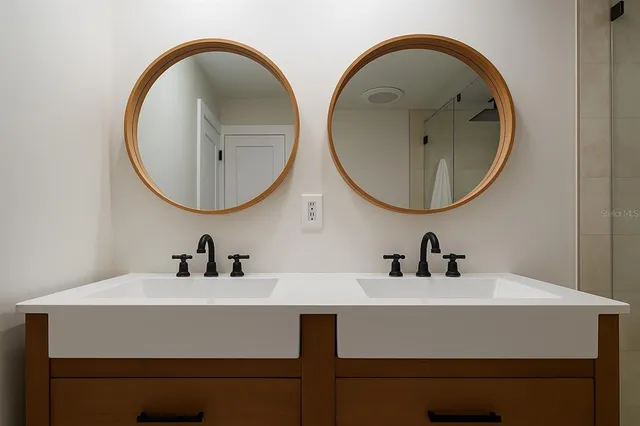 a bedroom with a bed and a mirror