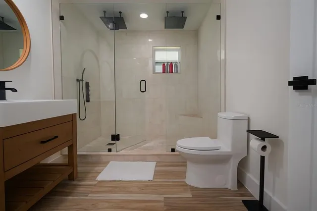 a bedroom with a bed and a wooden floor