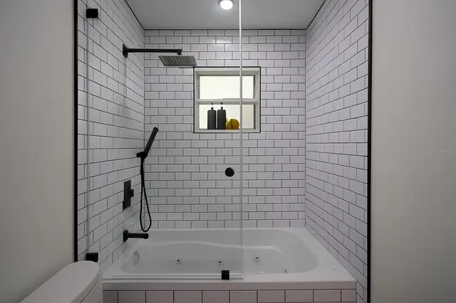 a bedroom with a bed and flat screen tv