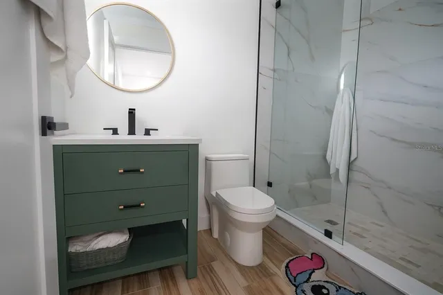 a bathroom with a toilet and a shower