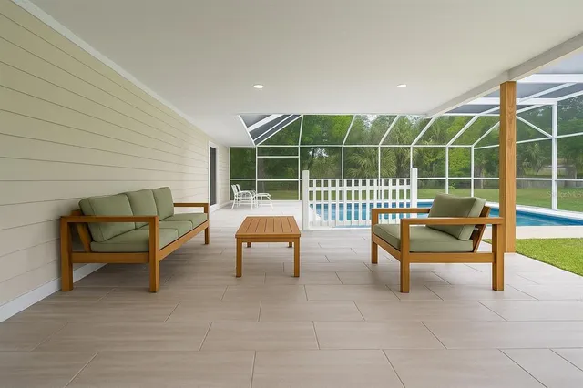 a view of a wooden deck with a chair and potted plants