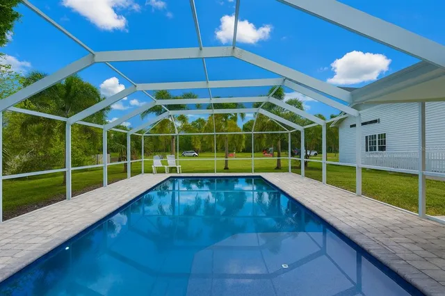 aerial view of residential houses with outdoor space and trees