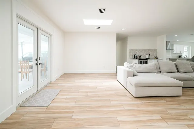 a view of a patio with a table and chairs and potted plants