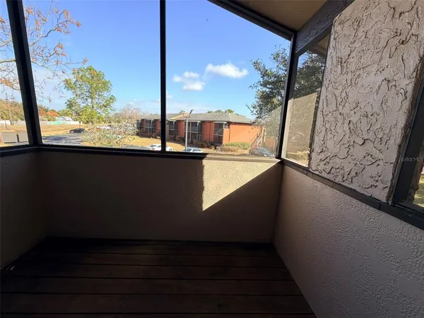 a view of a balcony with wooden floor and fence