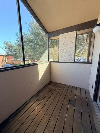 a view of a room with wooden floor