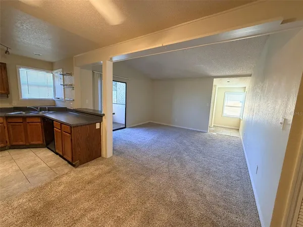 a kitchen with granite countertop a sink and a stove
