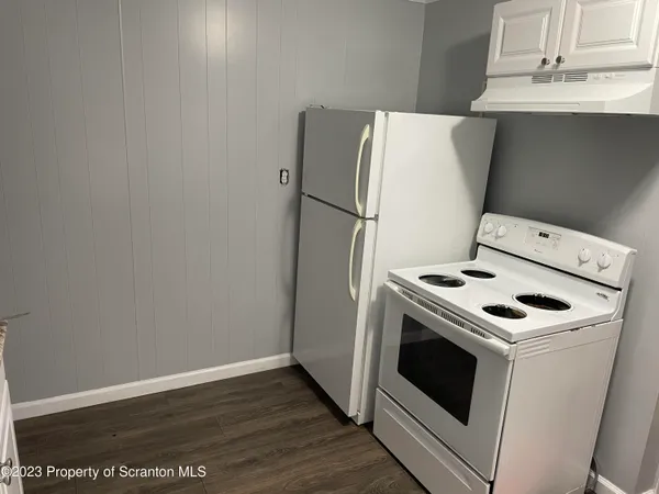 a white stove top oven sitting inside of a house