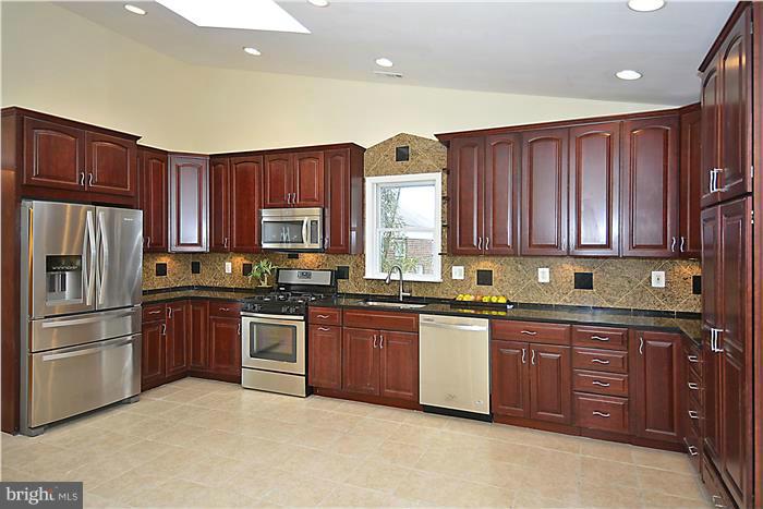 2300 Darrow Street Silver Spring, MD 20902 - Photo 12 of 30 a kitchen with stainless steel appliances granite countertop wooden cabinets a stove a sink dishwasher and a refrigerator