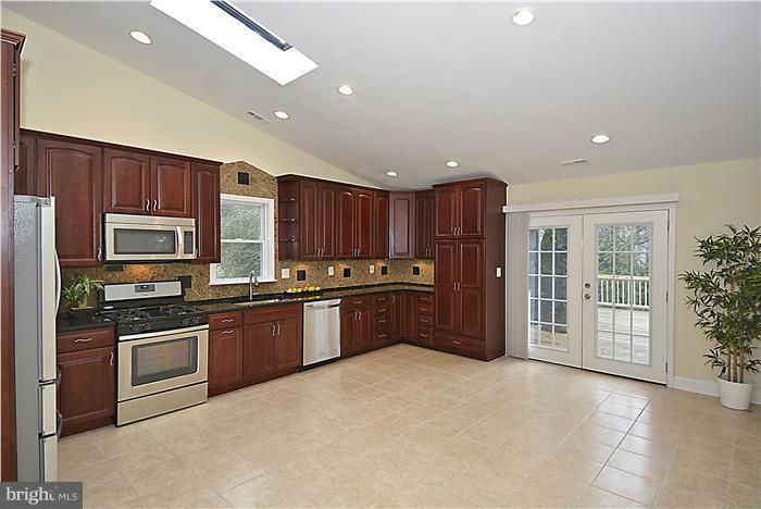 2300 Darrow Street Silver Spring, MD 20902 - Photo 13 of 30 a kitchen with stainless steel appliances granite countertop a refrigerator stove and sink