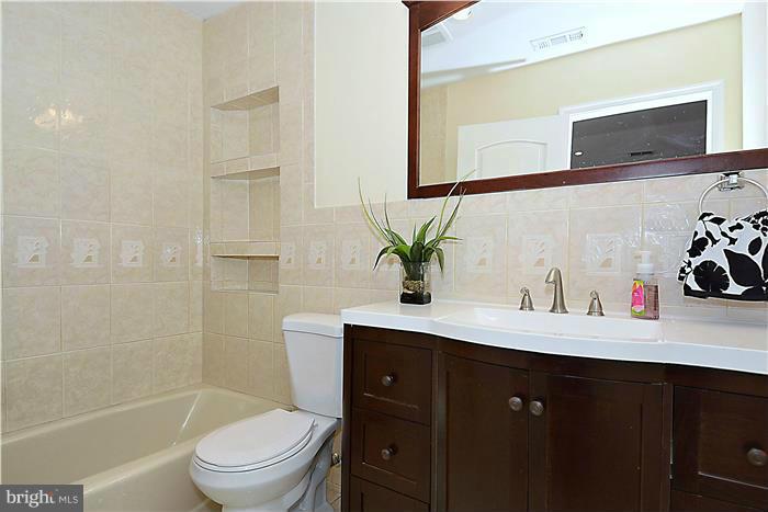 2300 Darrow Street Silver Spring, MD 20902 - Photo 17 of 30 a bathroom with a sink vanity mirror and toilet