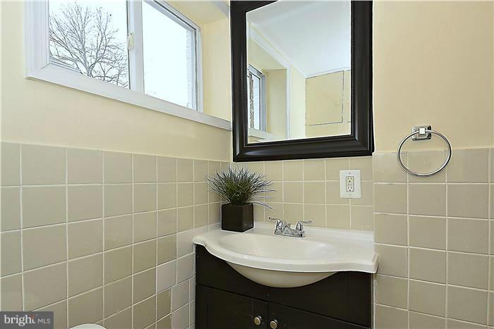 2300 Darrow Street Silver Spring, MD 20902 - Photo 26 of 30 a bathroom with a sink a mirror and a shower