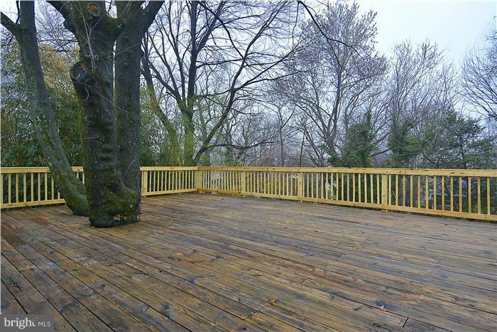 2300 Darrow Street Silver Spring, MD 20902 - Photo 5 of 30 a view of a deck with large trees and wooden fence