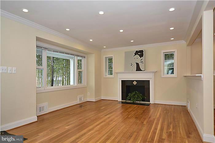 2300 Darrow Street Silver Spring, MD 20902 - Photo 7 of 30 a view of an empty room with wooden floor fireplace and a window