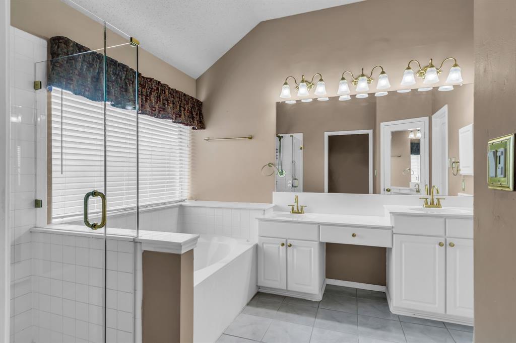 513 Cameron Lane Allen, TX 75002 - Photo 19 of 33 This ensuite master bath has an updated seamless shower, bright vanity lights, and a large frosted window!