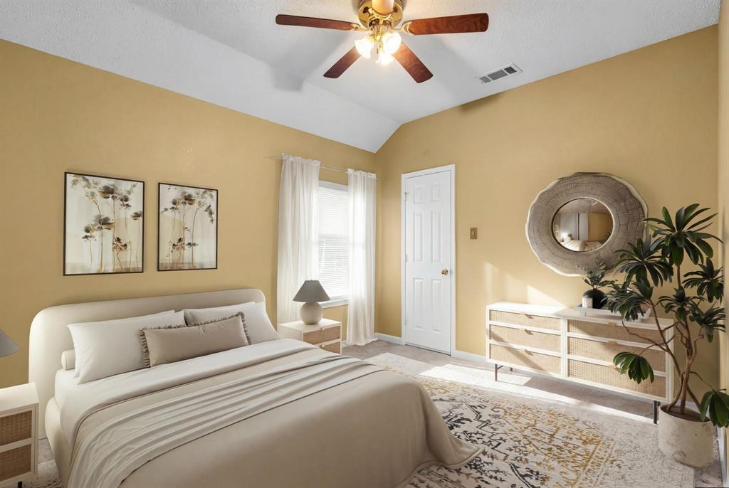 513 Cameron Lane Allen, TX 75002 - Photo 22 of 33 This virtualy staged guest bedroom features an angled ceiling, a ceiling fan, and light colored carpet.