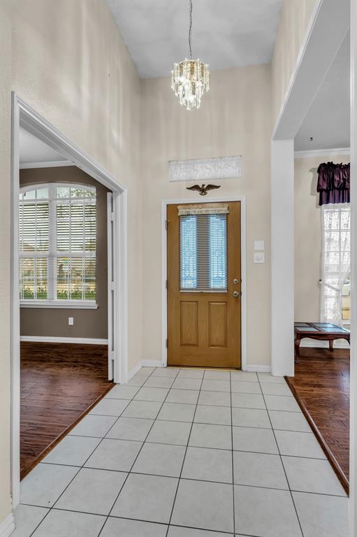 513 Cameron Lane Allen, TX 75002 - Photo 3 of 33 The foyer is bright and welcoming with a sparkling crystal light fixture.