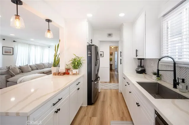 a kitchen with a sink stove top oven and microwave