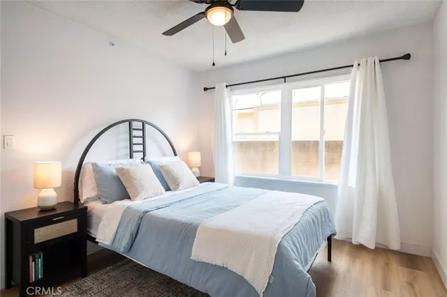 a large bed sitting in a bedroom next to a lamp