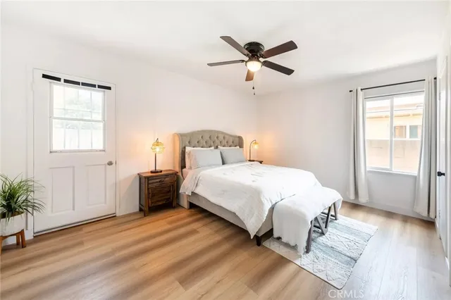 a bedroom with a bed and a potted plant