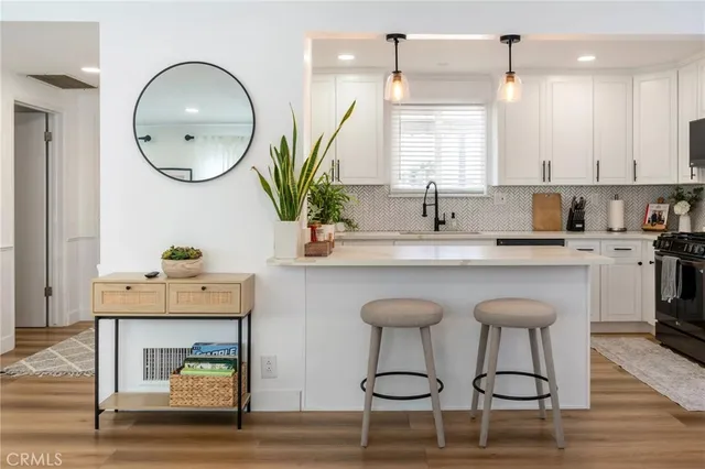 a kitchen with a sink cabinets and wooden floor