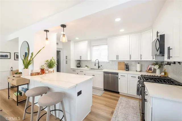 a kitchen with a sink stove top oven and refrigerator