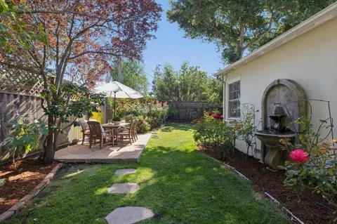 a view of backyard with seating space and trees