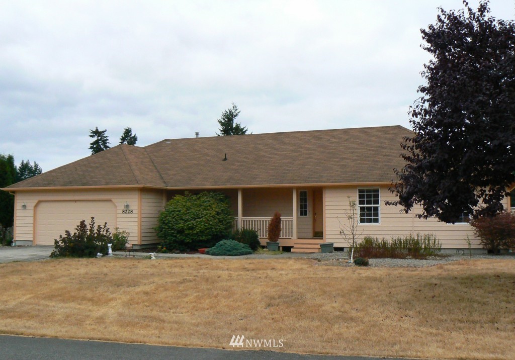 8228 Mullen Road Southeast Olympia, WA 98503 - Photo 1 of 1 a front view of a house with a yard and garage