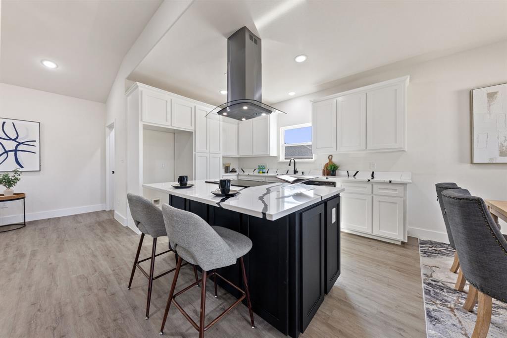 315 Windjammer Road Gun Barrel City, TX 75156 - Photo 11 of 32 a kitchen with kitchen island a sink a stove a dining table and chairs