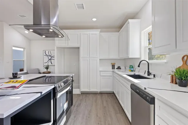 a kitchen that has a sink and a stove in it