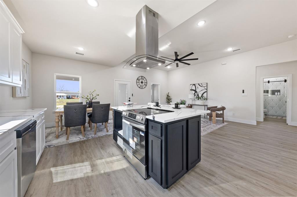 315 Windjammer Road Gun Barrel City, TX 75156 - Photo 15 of 32 a kitchen with a stove and a wooden floor