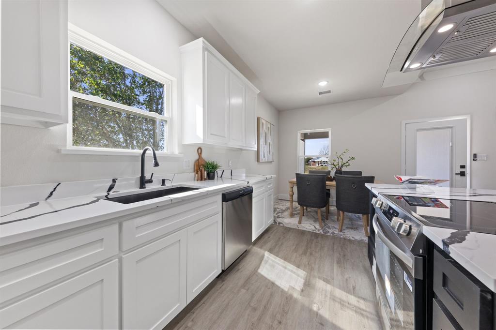 315 Windjammer Road Gun Barrel City, TX 75156 - Photo 16 of 32 a kitchen with kitchen island granite countertop a sink appliances cabinets and wooden floor