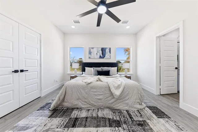 a bedroom with a bed and a chandelier