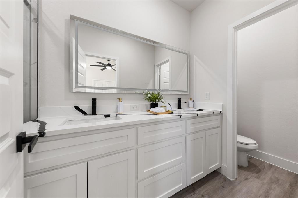 315 Windjammer Road Gun Barrel City, TX 75156 - Photo 20 of 32 a bathroom with a toilet sink and mirror