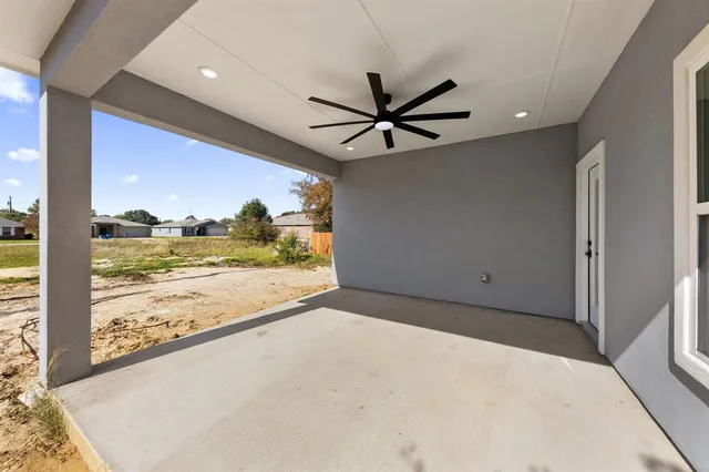 a view of a big room with wooden floor and a ceiling fan