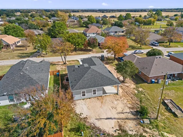 an aerial view of residential houses with outdoor space