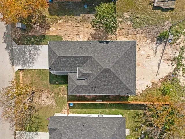 an aerial view of a house with a yard
