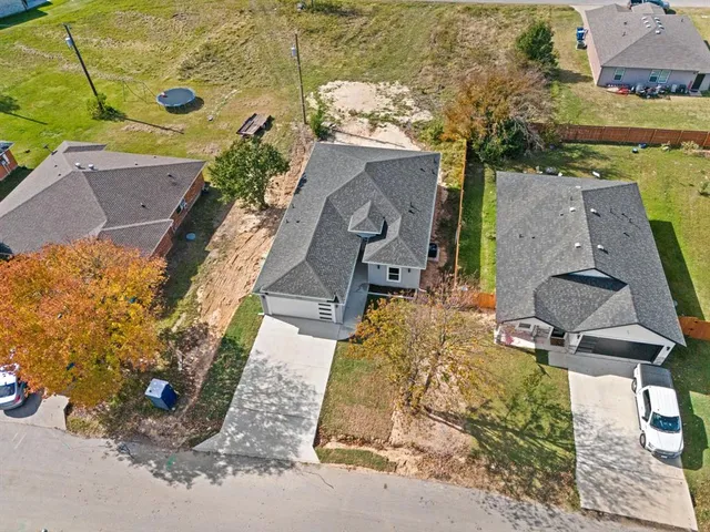 an aerial view of a house with a yard
