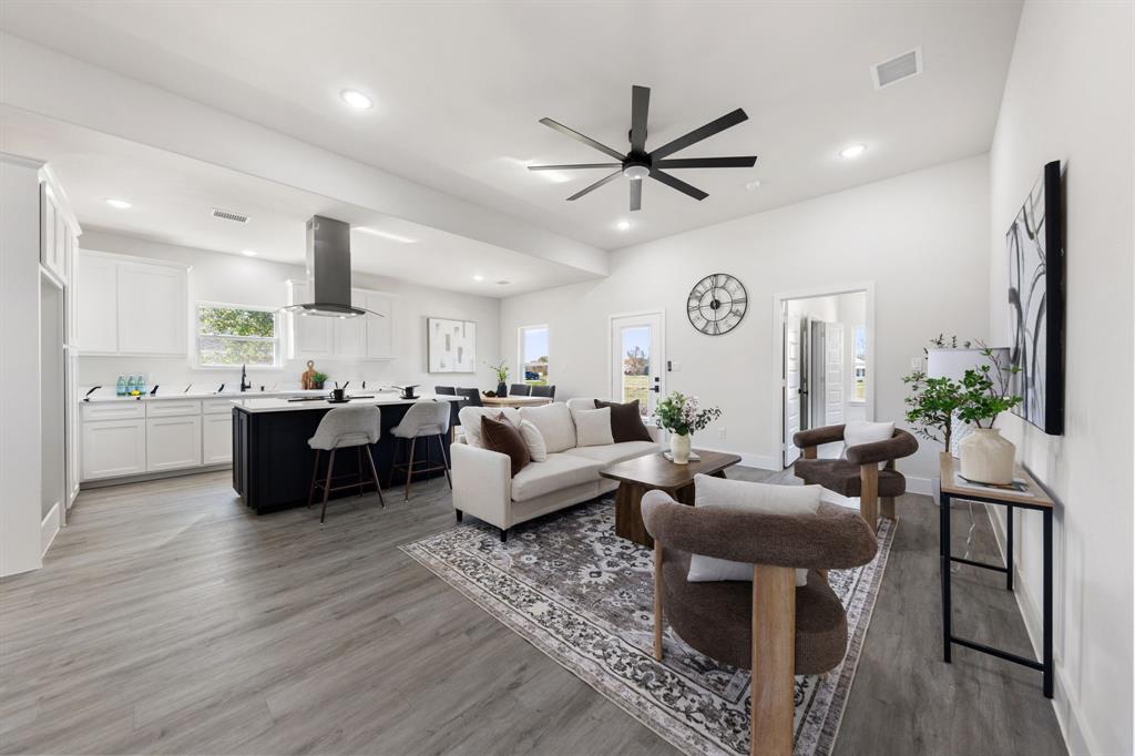 315 Windjammer Road Gun Barrel City, TX 75156 - Photo 4 of 32 a living room with couches a fireplace and kitchen view with wooden floor