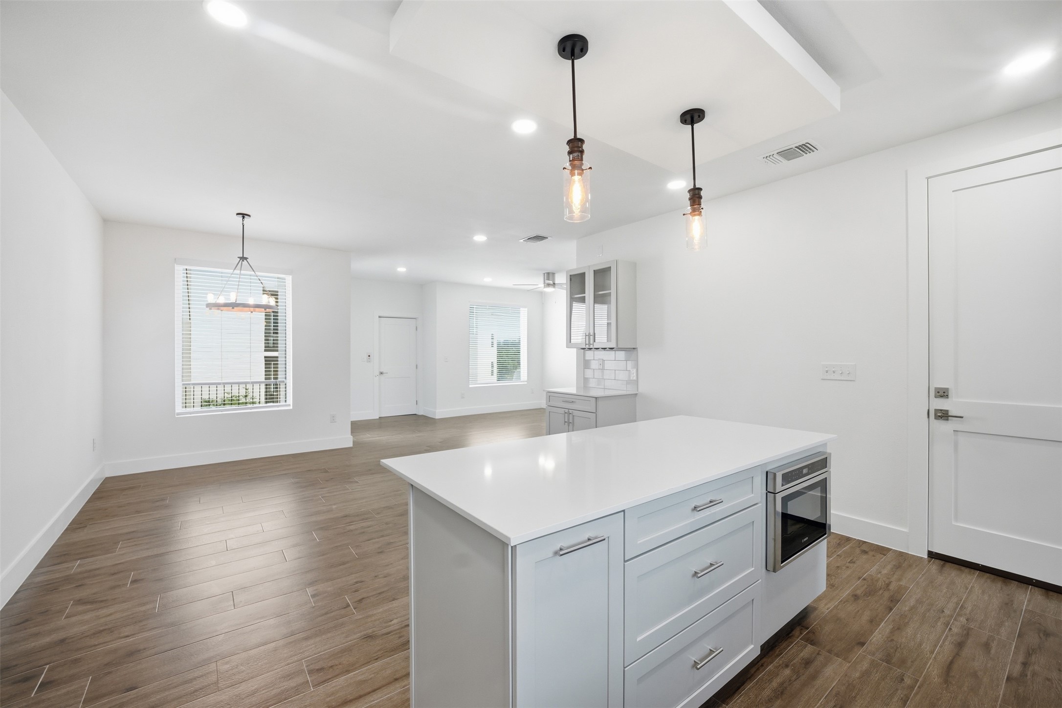 4300 Mansfield Dam Road, Unit 1021 Austin, TX 78734 - Photo 16 of 40 Stylish floating ceiling over the kitchen island with integrated lighting creates a warm, ambient glow and adds a striking modern architectural touch.