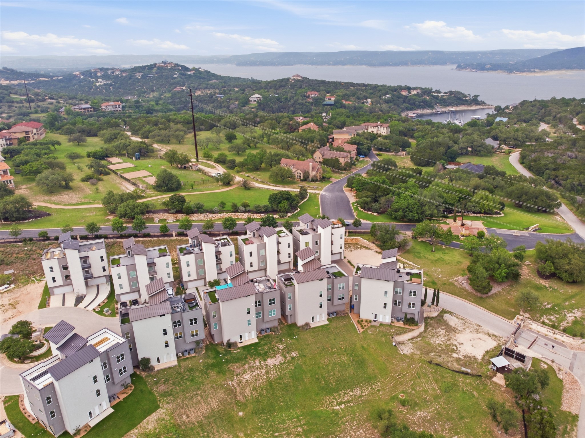 4300 Mansfield Dam Road, Unit 1021 Austin, TX 78734 - Photo 3 of 40 Modern multi-story residences featuring contemporary architecture with flat and sloped rooflines, exterior balconies. Gated.