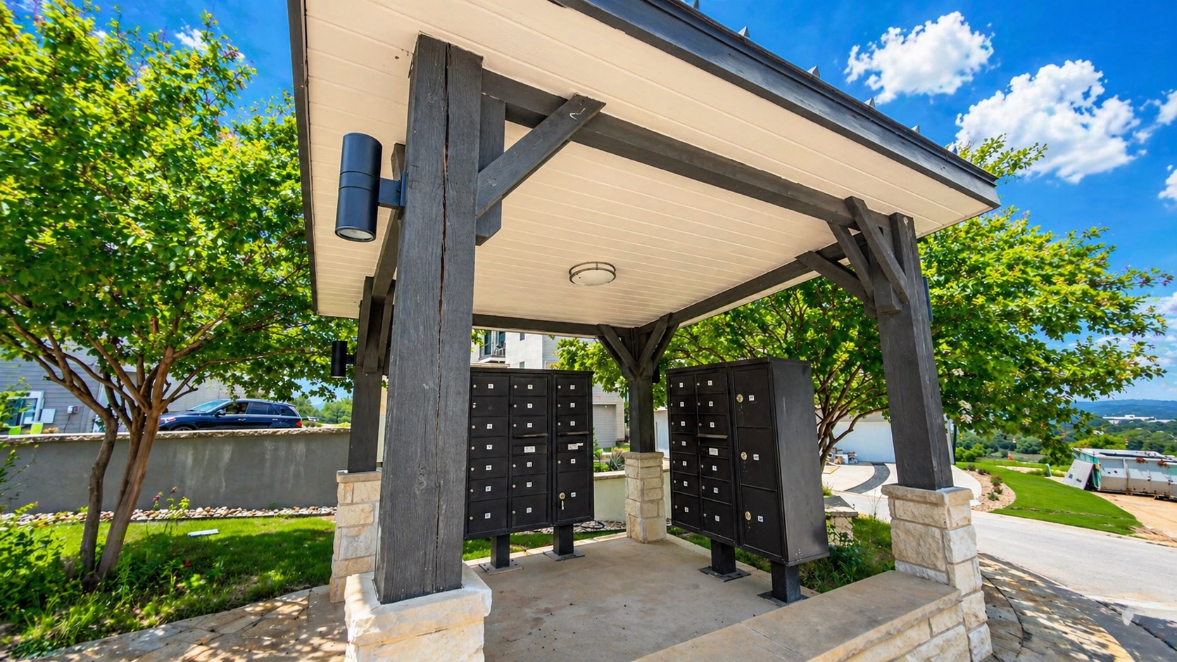 4300 Mansfield Dam Road, Unit 1021 Austin, TX 78734 - Photo 35 of 40 Covered community mailbox station featuring robust dark wood columns and stone bases