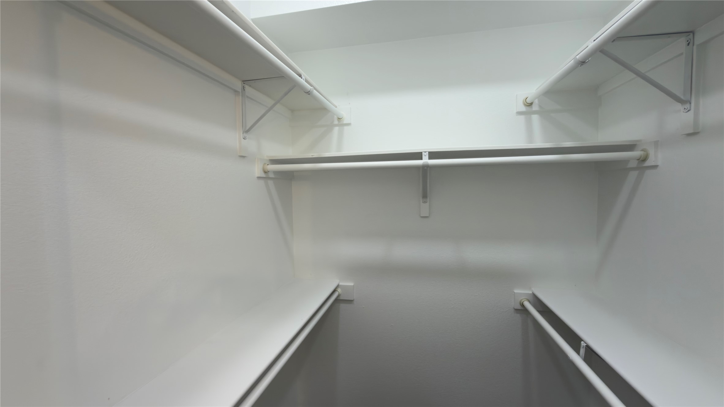 4300 Mansfield Dam Road, Unit 1021 Austin, TX 78734 - Photo 38 of 40 Walk-in closet featuring white walls, integrated shelving, and multiple hanging rods for organization